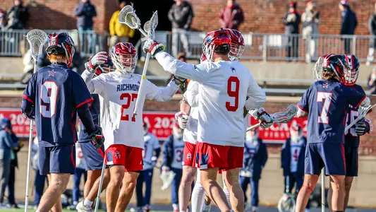 Lucas Littlejohn and Cole Hayden celebrate a goal during Richmond's 17-7 season-opening win over Robert Morris on Feb. 7, 2026