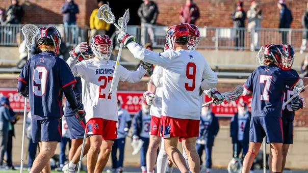 Lucas Littlejohn and Cole Hayden celebrate a goal during Richmond's 17-7 season-opening win over Robert Morris on Feb. 7, 2026