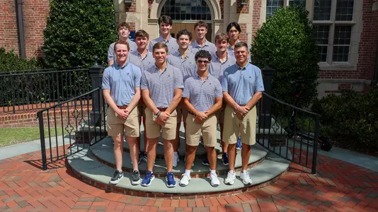The 2025-26 men's golf team gathers on a staircase for a team photo
