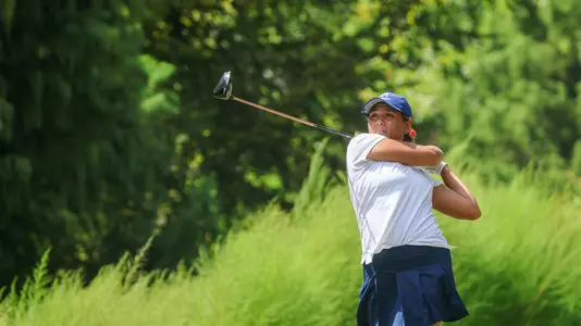 Maya Beasley holds a wide follow through after her tee shot