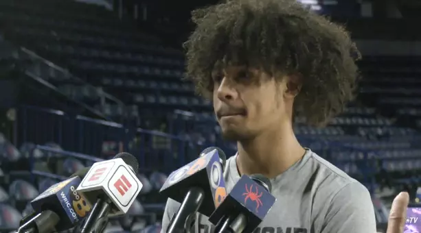 Aiden Argabright speaks to a row full of microphones