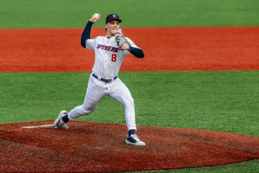 Chase Topolski strides towards home plate from the pitching rubber.