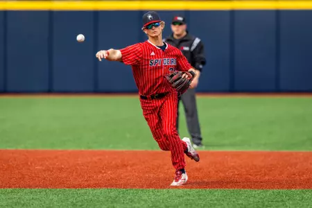Noah Haught throws the ball towards first base from short stop