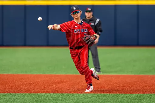Noah Haught throws the ball towards first base from short stop