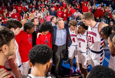 The Richmond team huddles around Coach Mooney