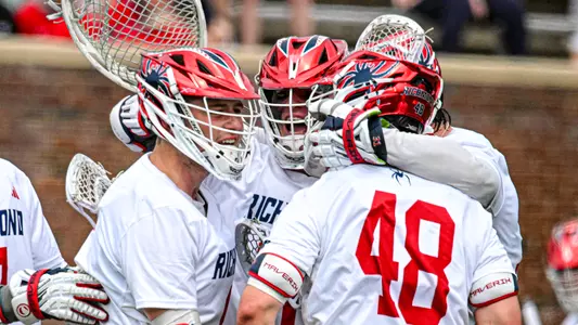 Spider men's lacrosse defenders celebrate a goal against Georgetown on March 7, 2026