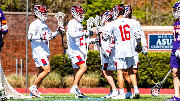 Lucas Littlejohn is embraced by teammates after scoring a goal against Hobart on March 28, 2026