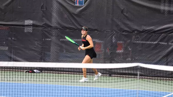 Elizabeth Novak about to hit a tennis ball