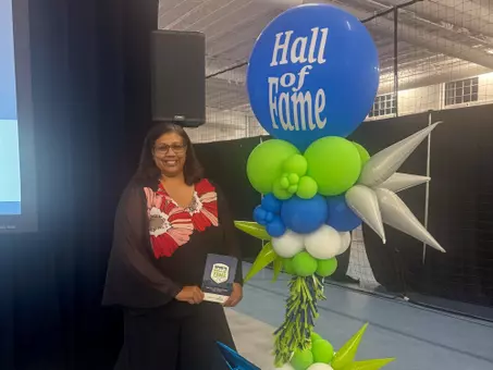 LaRee Sugg poses with her Chesterfield Sports Hall of Fame plaque
