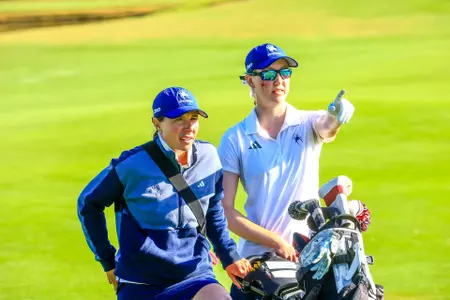 Calle Barlow and Addie Doroh stare at the green as Doroh points