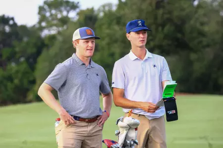 Drew Carlin and Cole Ekert check their yardage books