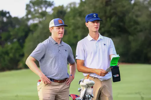 Drew Carlin and Cole Ekert check their yardage books