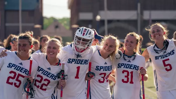 WLAX Team members smile after defeating Davidson 16-7