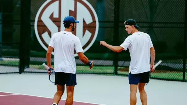Cole Brashear and Davis Wiley high fiving during doubles