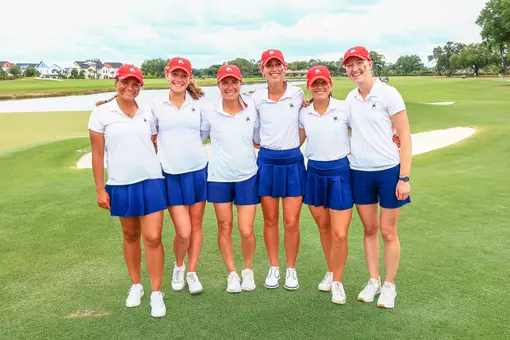 The women's golf team poses on the 18th green at Evermore Resort