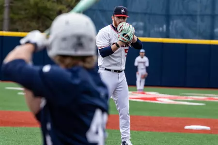 Joey Giordano looks over his glove before throwing the ball.