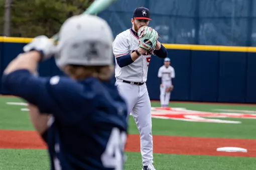 Joey Giordano looks over his glove before throwing the ball.