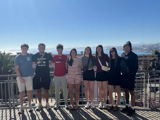 Spider student-athletes pose on an overlook in Chile