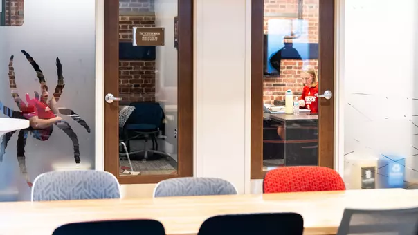 A Spider studies alone in a conference room