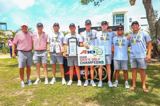The men's golf team poses after winning the A-10 Championship