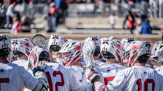 Group shot of the Richmond men's lacrosse team in a huddle