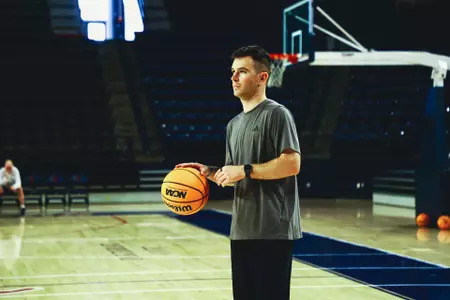 Quinn Harmon prepares to throw a pass in the Robins Center