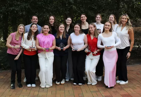 The swimming & diving team poses with its academic awards