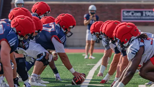 Richmond offensive and defensive linemen lining up during a Richmond football practice