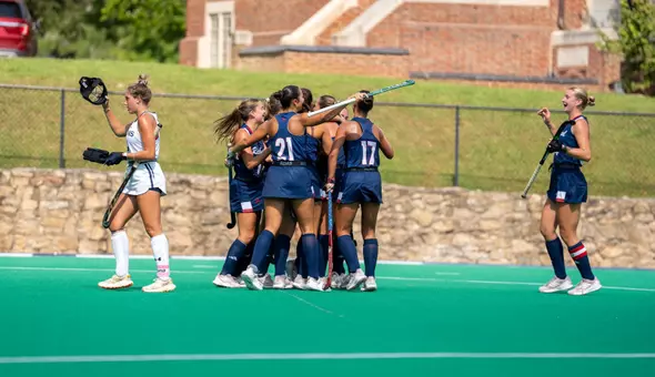 Spider Field Hockey celebrates a goal against Queens (NC)