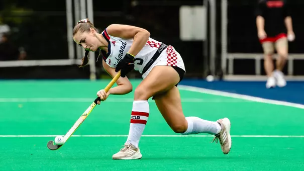 Elen Nicholls passes the ball up field for Spider field hockey
