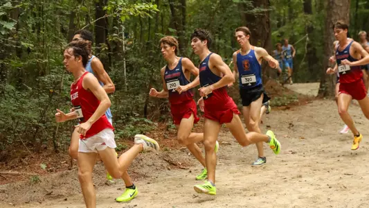 A pair of Spiders runners run through the woods at the Adidas XC Challenge