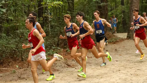 A pair of Spiders runners run through the woods at the Adidas XC Challenge