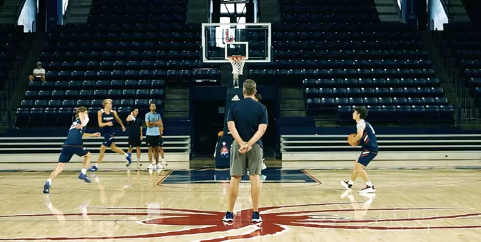 Chris Mooney observes layups during warmups