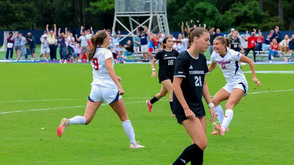 Morgane Zinn runs to teammate Camden Henard after scoring vs St. Bonaventure