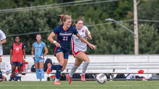 Gwen Howell sprints to clear a ball