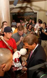 Nick Saban signed autographs on the way in and the way out of SEC Media Days.