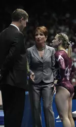 David and Sarah Patterson confer with junior Ricki Lebegern during Friday's Alabama-Kentucky meet.