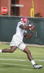 Julio Jones snags a pass from quarterback Greg McElroy during the first practice of the season on Thursday morning.