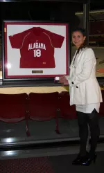 Alex Butera stands with her framed jersey at the awards banquet.