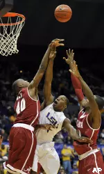 LSU forward Tasmin Mitchell, center, has his shot blocked by Alabama forward Justin Knox (40) as Alabama forward Chris Hines, right, adds pressure during the first half.