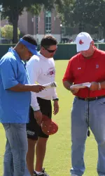 Head coach Mitch Gaspard talks with Major League scouts in attendance at Alabama's pro scout day.