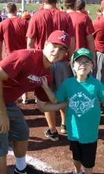 Sophomore Brett Booth poses with one of the players at Saturday's game.