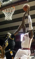 Alabama forward JaMychal Green (1) shoots past VCU forward Juvonte Reddic (15).
