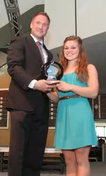 Dr. Paul Plinske, chair of the NCAA Gymnastics Championship committee, presents Alabama junior All-American Rachel Terry with the 2011 NCAA Women's Gymnastics Elite 88 Award.