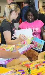The gymnasts helped the University Place students, many of which lost everything in the storm, pick out items to take home.