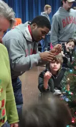 Senior Kenny Roberts pitched hanging ornaments on the tree at the Sprayberry Education Center