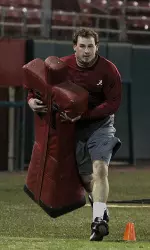Andrew Miller carries a tackling dummy during one portion of Thursday's obstacle course.