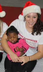 Sophomore All-American Kayla Williams and a friend on the trampoline in the Crimson Tide's practice gym.