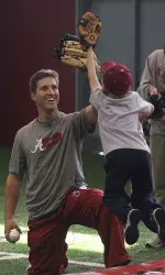 Jon Kelton gives one of the more than 100 kids at today's clinic a high-five.