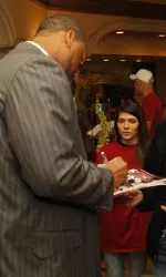 Michael Williams signs autographs before going on to address the media at the 2012 SEC Media Days.